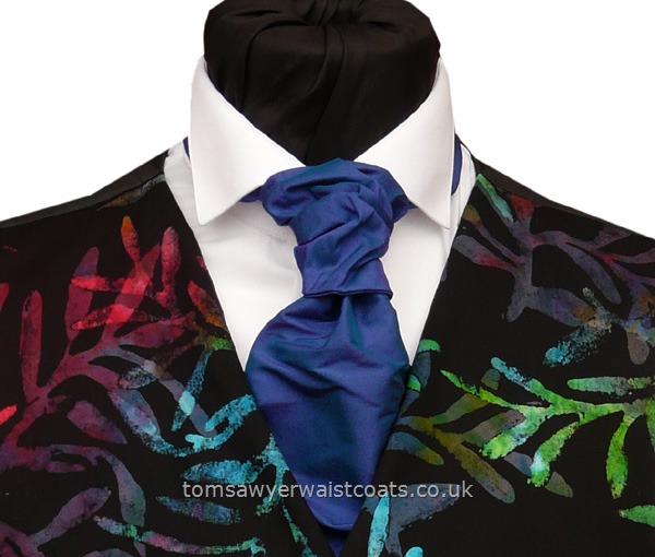 Order the featured neckwear here or, to choose a different style, select a neckwear category from the menu. The tie in the picture is a two-tone scrunchie tie, with shimmers of blue, purple and green to bring out the colours in the waistcoat. Our picture shows the following:- Style- Self-Tied Scrunchie- Colour- Electric Blue- Fabric- Silk Dupion- Please Note: Silk dupion is a natural fibre and there may be irregularities in the weave. This is par....