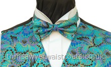 Shades of Turquoise, blue, cornflower blue and lavender with gold detail feature on this 100% cotton print, ready tied bowtie. -