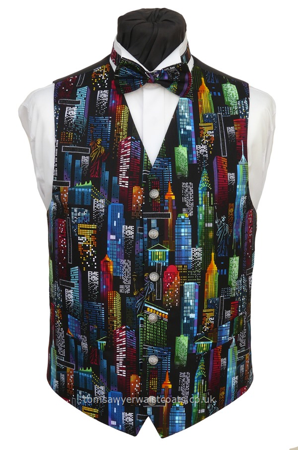 New York city skyline at night on a black background.As with all Tom Sawyer waistcoats, this will be made to order and is available with extra length if required. Please supply your measurements and height. Waistcoat Style- TS544- Front Fabric- Cotton- Colour- Multi coloured pattern on black- Buttons- Silver patterned- Back & Lining- Black Polyester- You can click here to view our waistcoat size chart.