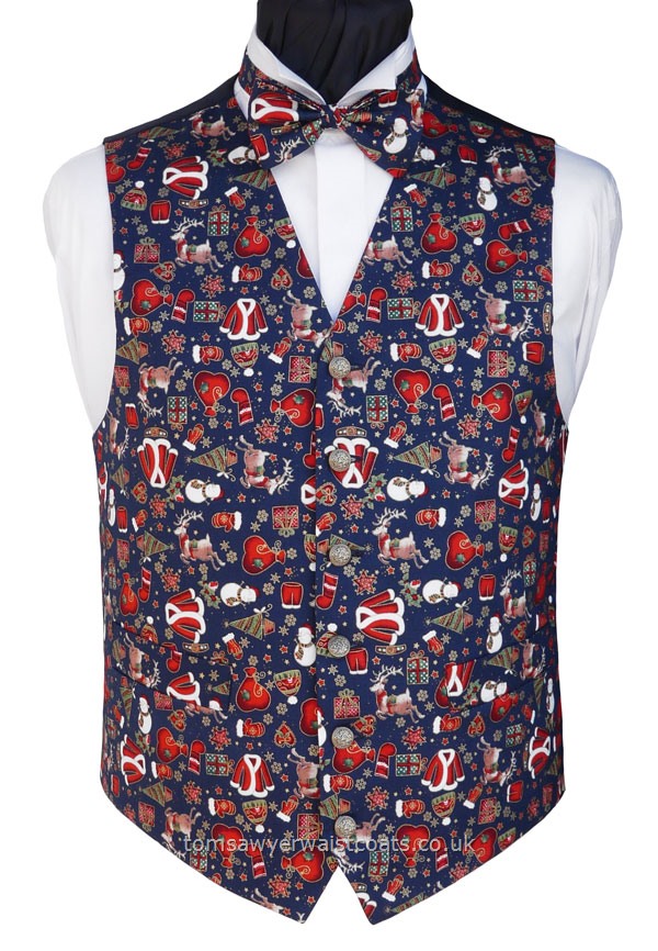 An assortment of Christmas necessities scattered on a blue background.. A fun Christmas waistcoat. Waistcoat Style- TS559- Front Fabric- 100% Cotton- Colour- Multi on Blue- Buttons- Gold Patterned- - Back & Lining- Navy Polyester twill- You can click here to view our waistcoat size chart. -