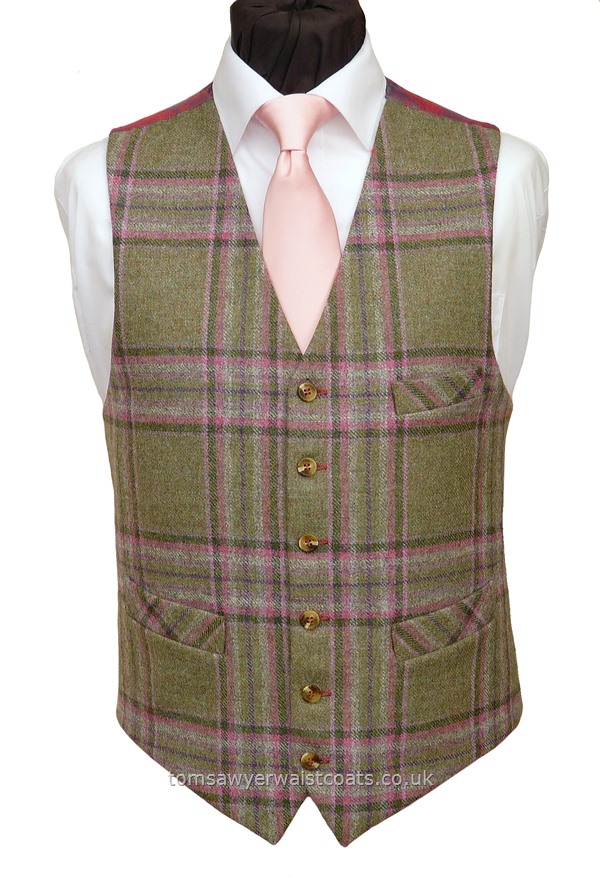 Front British Tweed, 100% Wool, woven in Yorkshire.A sage green tweed waistcoat with an overcheck of pinks and purple. This waistcoat features a striking paisley back and lining fabric which is made up of pink and red thread which shimmers lavender/lilac colours.Featuring a lower cut, shaped neckline and additional breast pocket. Waistcoat Style- TS557- Front Fabric- 100% Wool Tweed- Colour- Green, Pink and purple- Buttons- Horn effect- Back & Li....