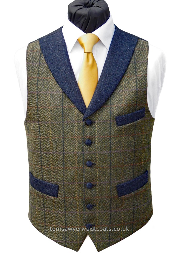 Front British Tweed, 100% Wool, woven in Yorkshire.A green tweed waistcoat with an overcheck of yellow and blue. This waistcoat features a contracting flint blue tweed shawl collar and pockets. - Waistcoat Style- TS569- Front Fabric- 100% Wool Tweed- Colour- Green Check and Flint Blue- Buttons- Blue Tweed Covered- Back & Lining- Navy Polyester Twill- You can click here to view our waistcoat size chart.